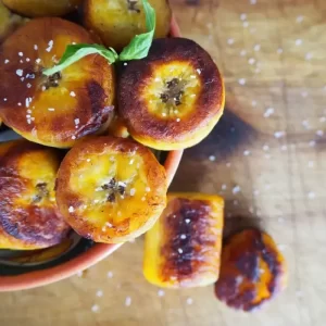 Slices of ripe plantains that have been fried to a golden brown perfection.
